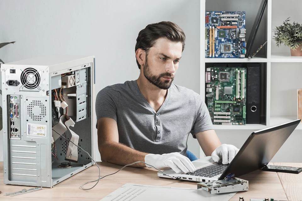 Man at a computer and laptop