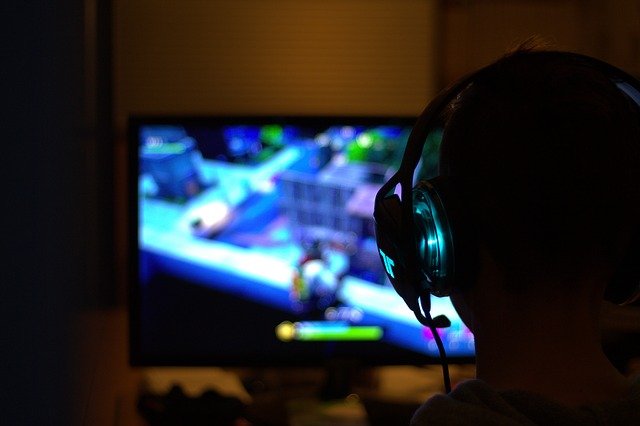 Gamer with headset and monitor